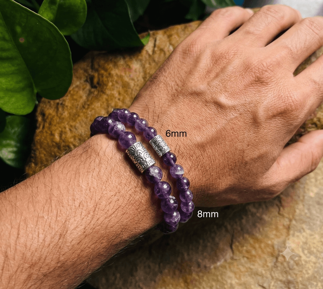 An amethyst bracelet in 6mm and 8mm beads worn together, showing the difference in bead size